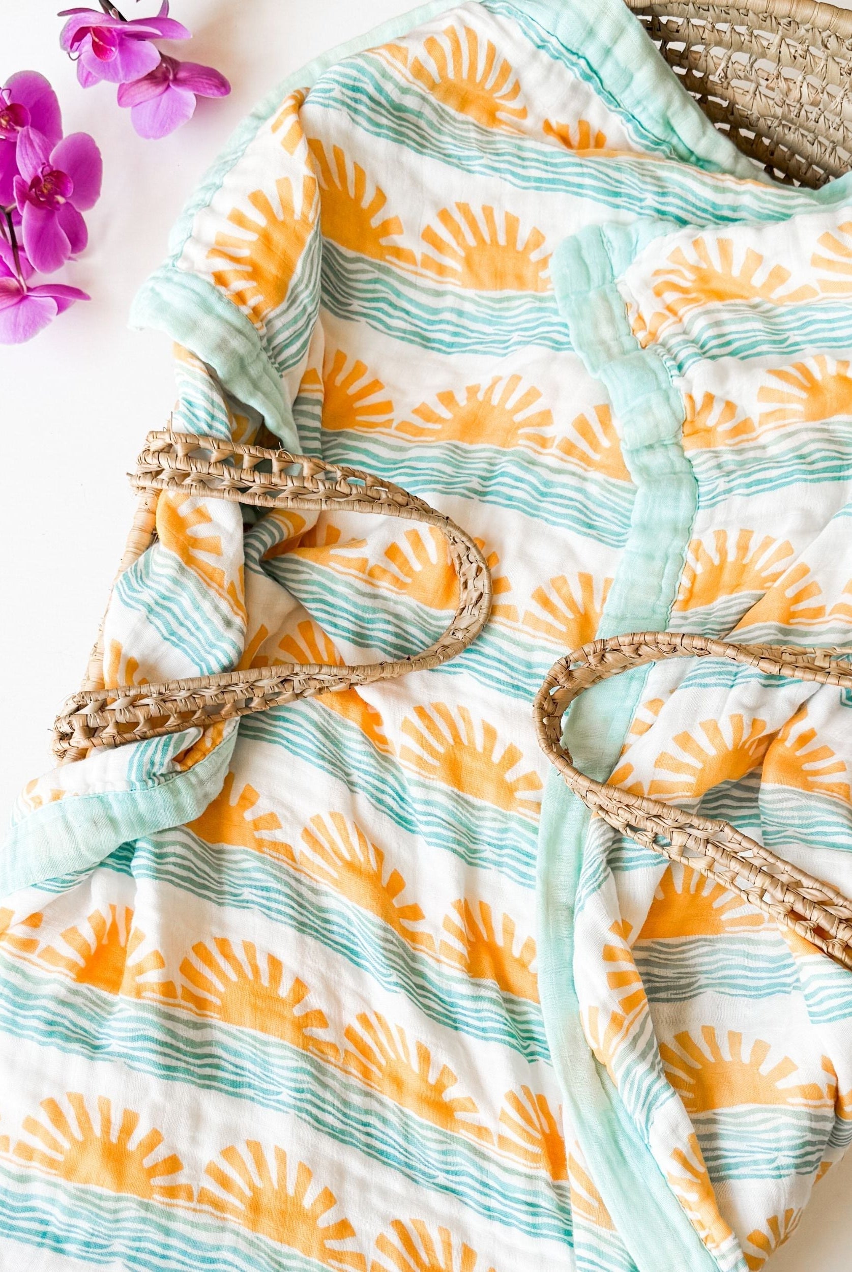 beautiful sun and wave print organic muslin baby blanket. Here come the son themed gift with aqua trim.