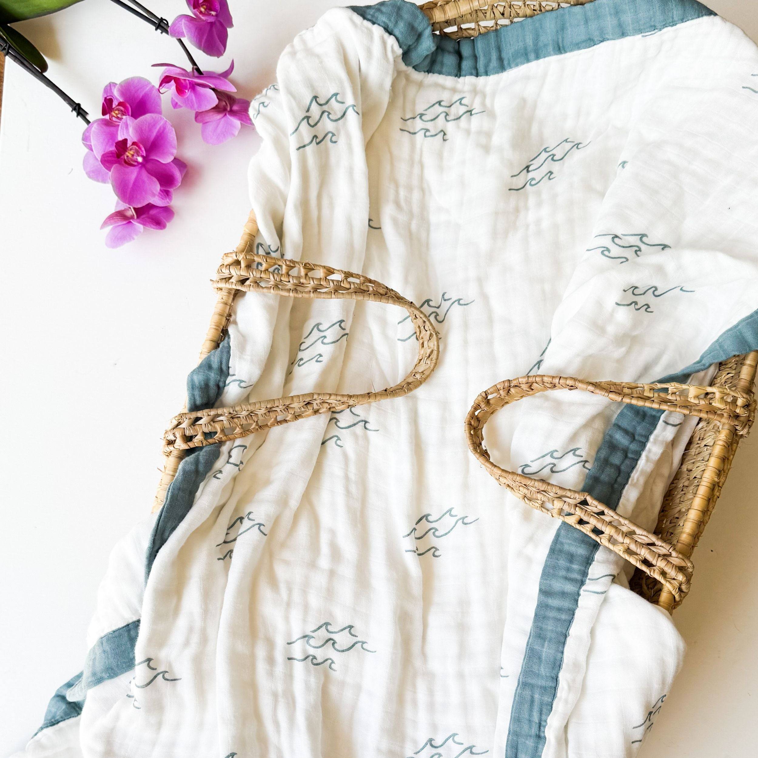 beautiful wave design baby blanket in a grass basket moses