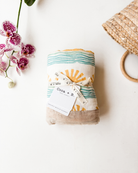 Blue Sun + Wave – Sand Trim | 6-Layer Organic Bamboo Baby Blanket - Coca + B.