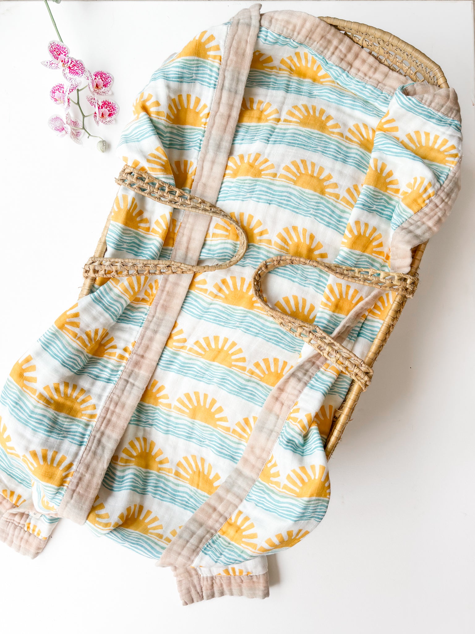 Baby wrap with sun and wave pattern on a white background