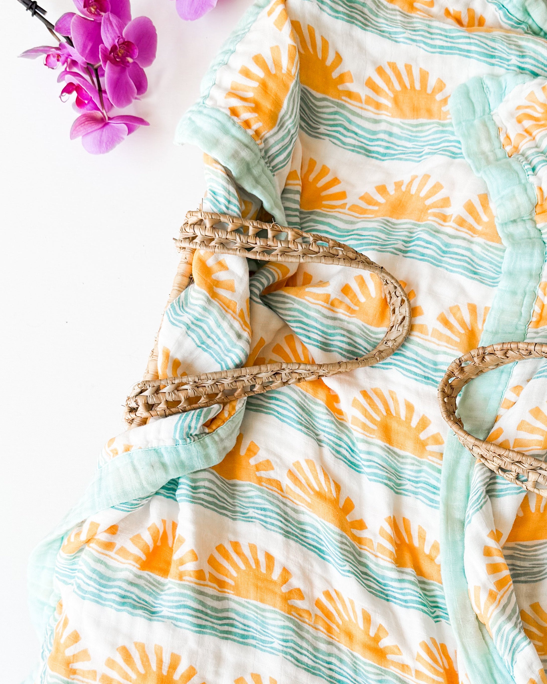 sun and wave pattern on a white surface with purple flowers.